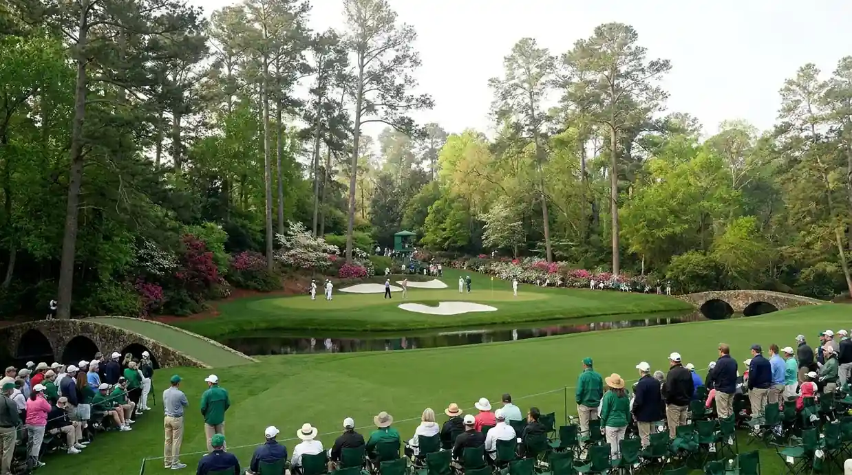 Amen Corner at Augusta National during the Masters with spectators lining the 12th hole