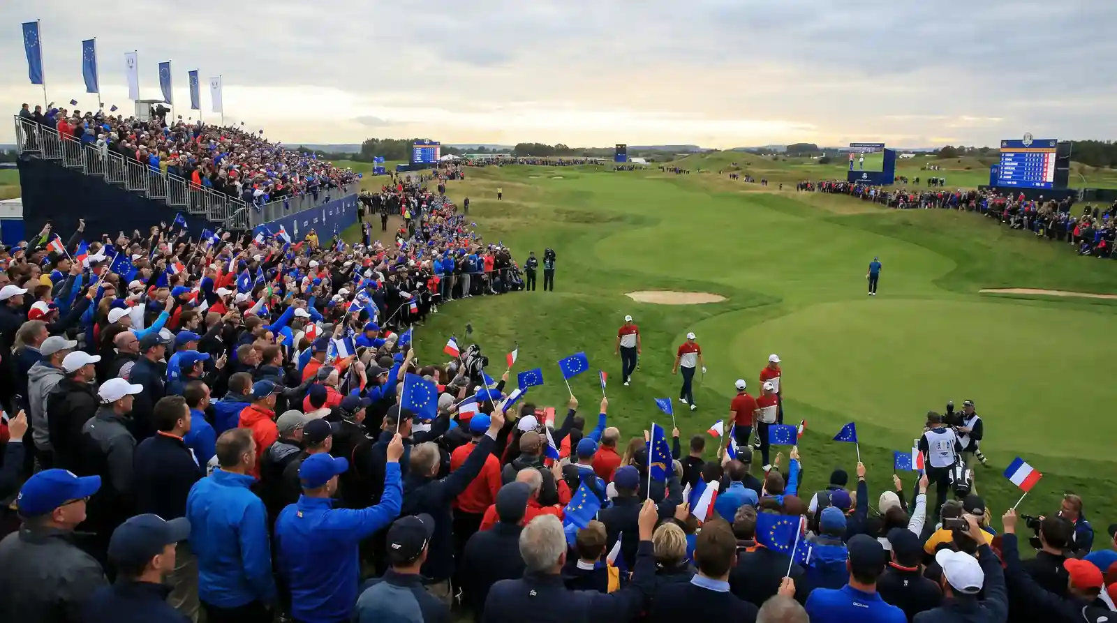 Large European crowd celebrating a crucial point at a Ryder Cup venue